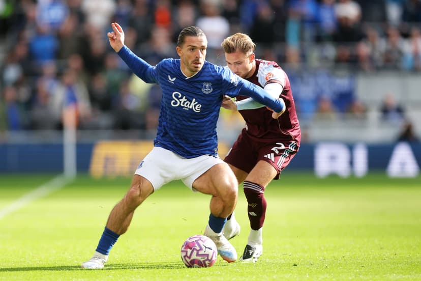 Jack Grealish of Everton is challenged by Matty Cash