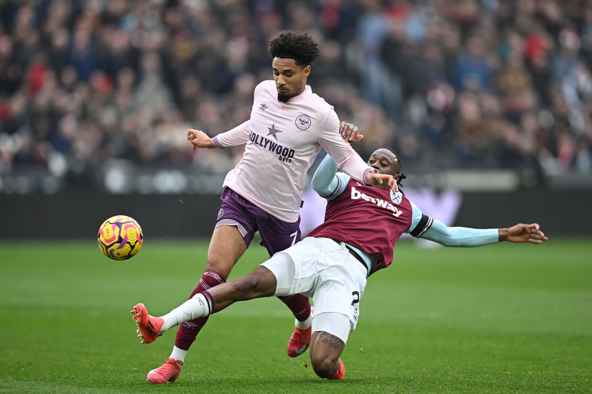 Aaron Wan-Bissaka of West Ham United is battles for possession with Kevin Schade of Brentford