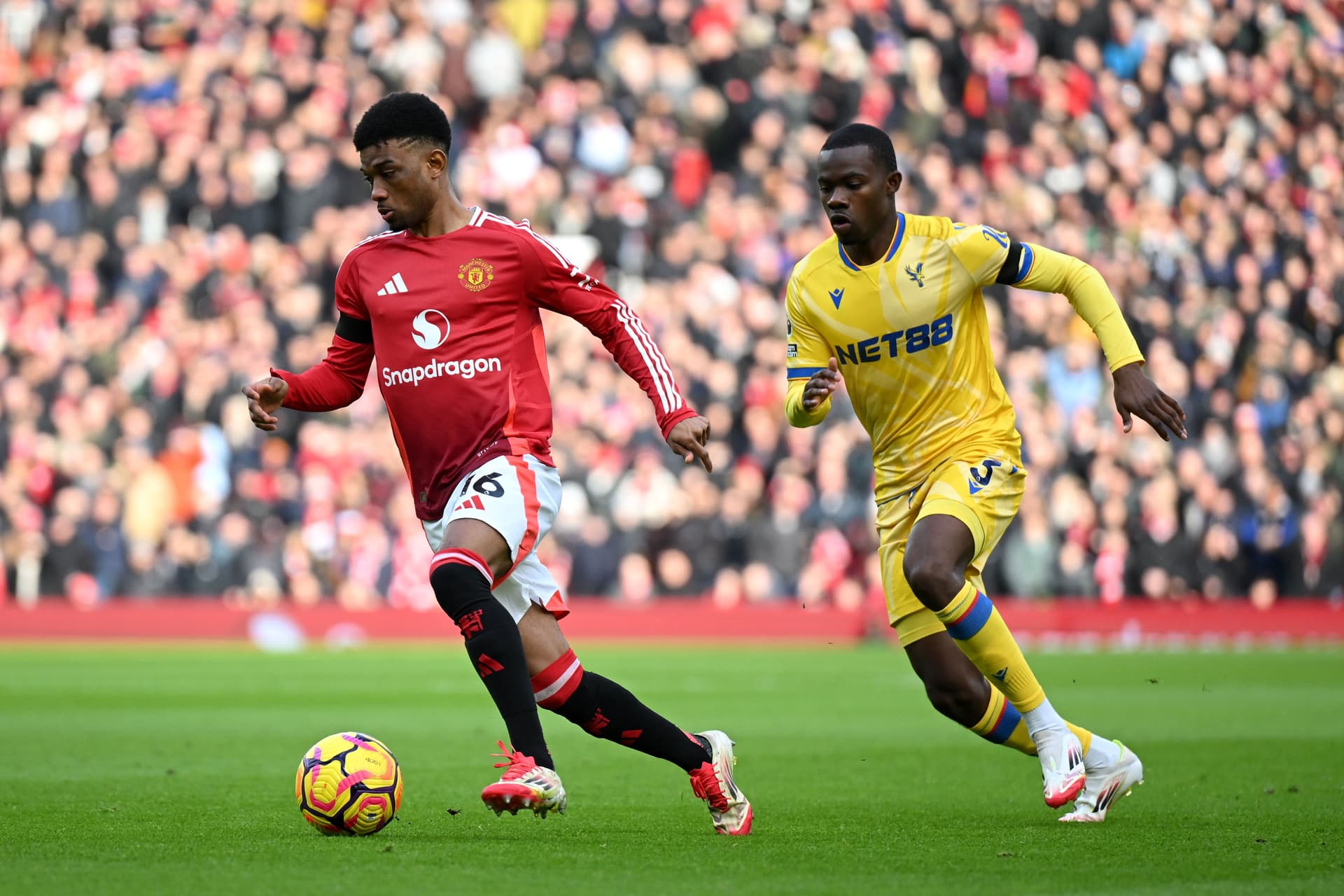 Amad Diallo of Manchester United runs with the ball under pressure