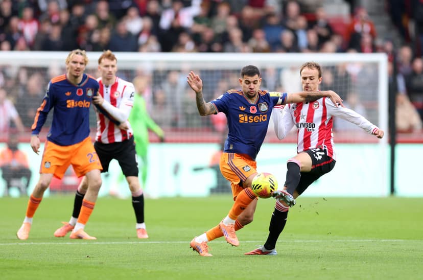 Bruno Guimaraes of Newcastle United and Mikkel Damsgaard of Brentford compete for the ball