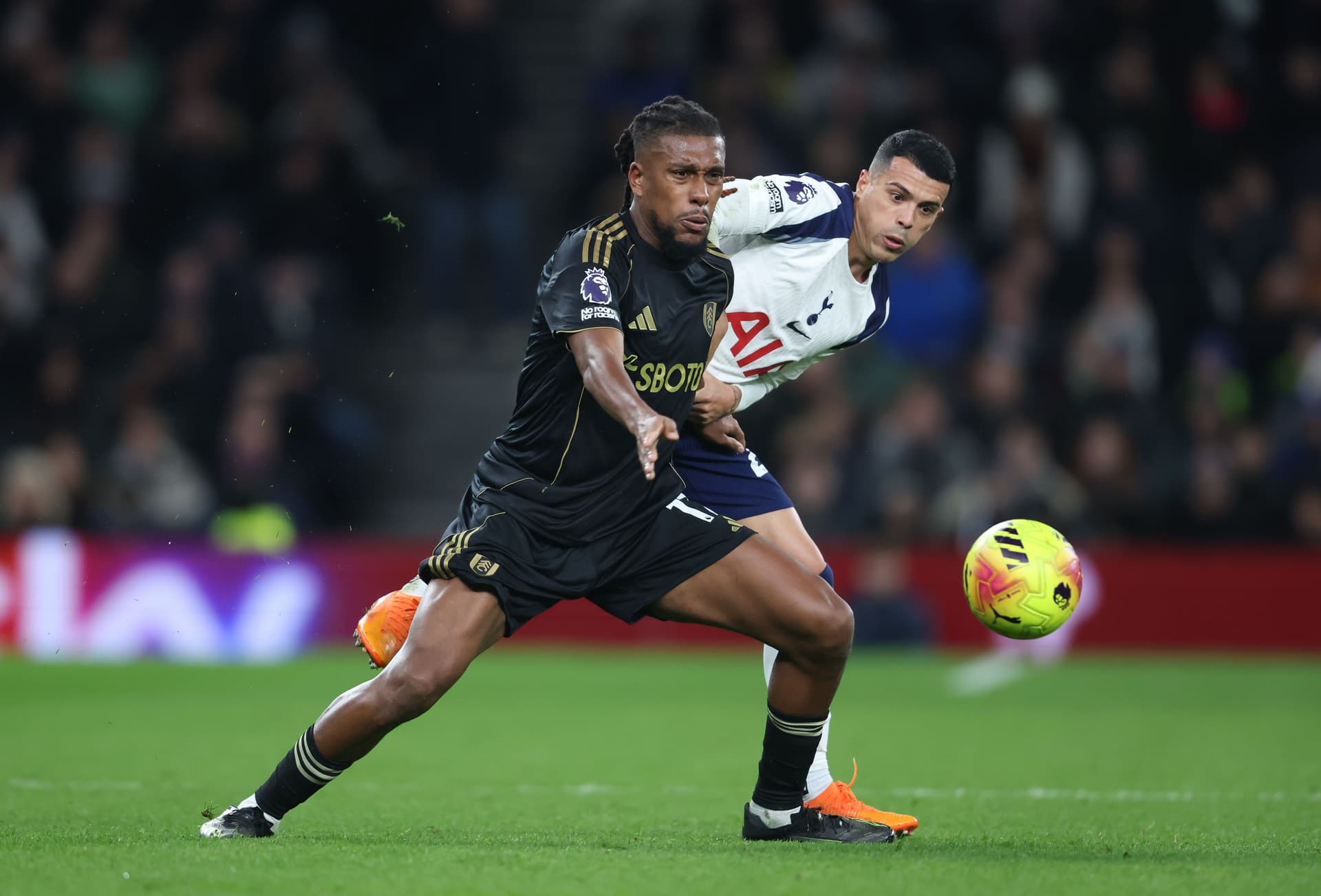 Fulham's Alex Iwobi and Tottenham Hotspur's Pedro Porro during the Premier League match