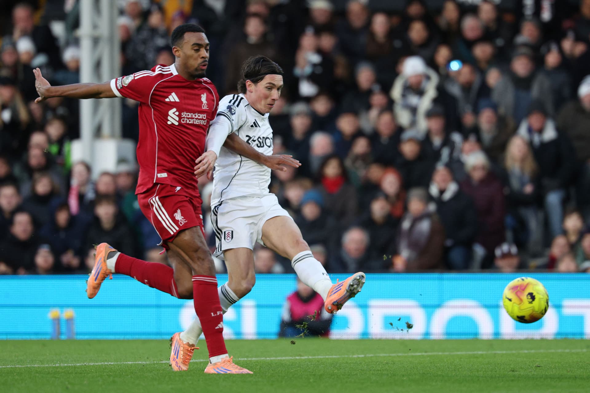 Fulham's Welsh midfielder #08 Harry Wilson (R) scores the opening goal to take the lead 1-0