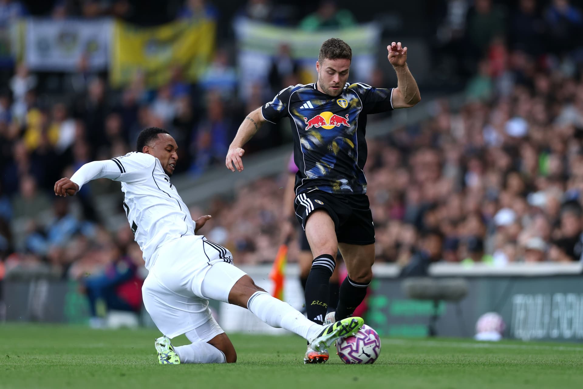 Gabriel Gudmundsson of Leeds United is challenged by Kenny Tete