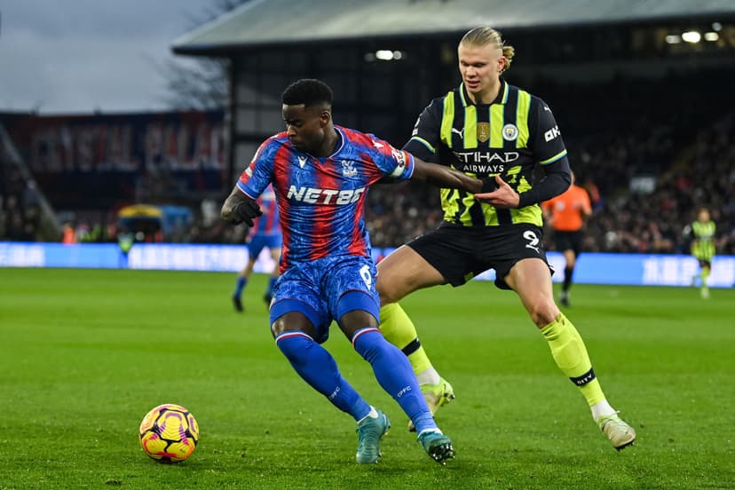 Marc Guehi fights for the ball with Erling Haaland