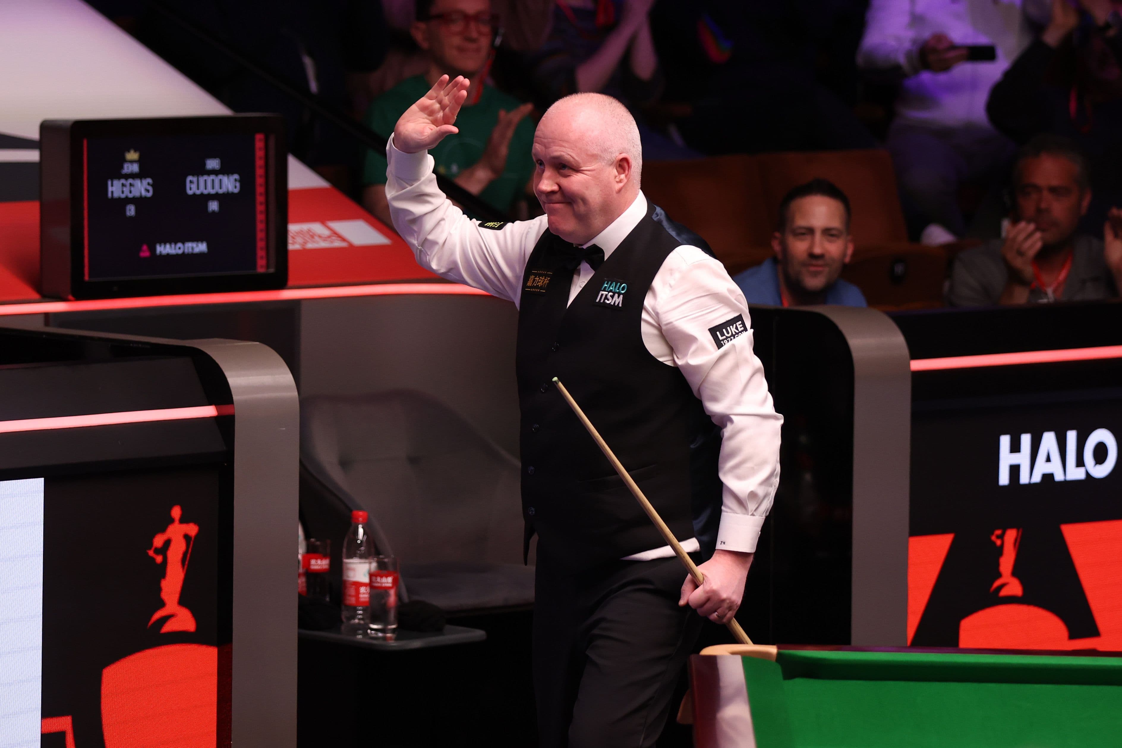 John Higgins of Scotland celebrates victory against Xiao Guodong of China