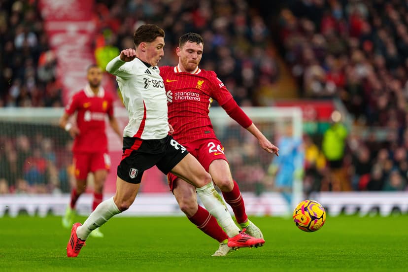 Liverpool's Andrew Robertson battles for possession with Fulham's Harry Wilson