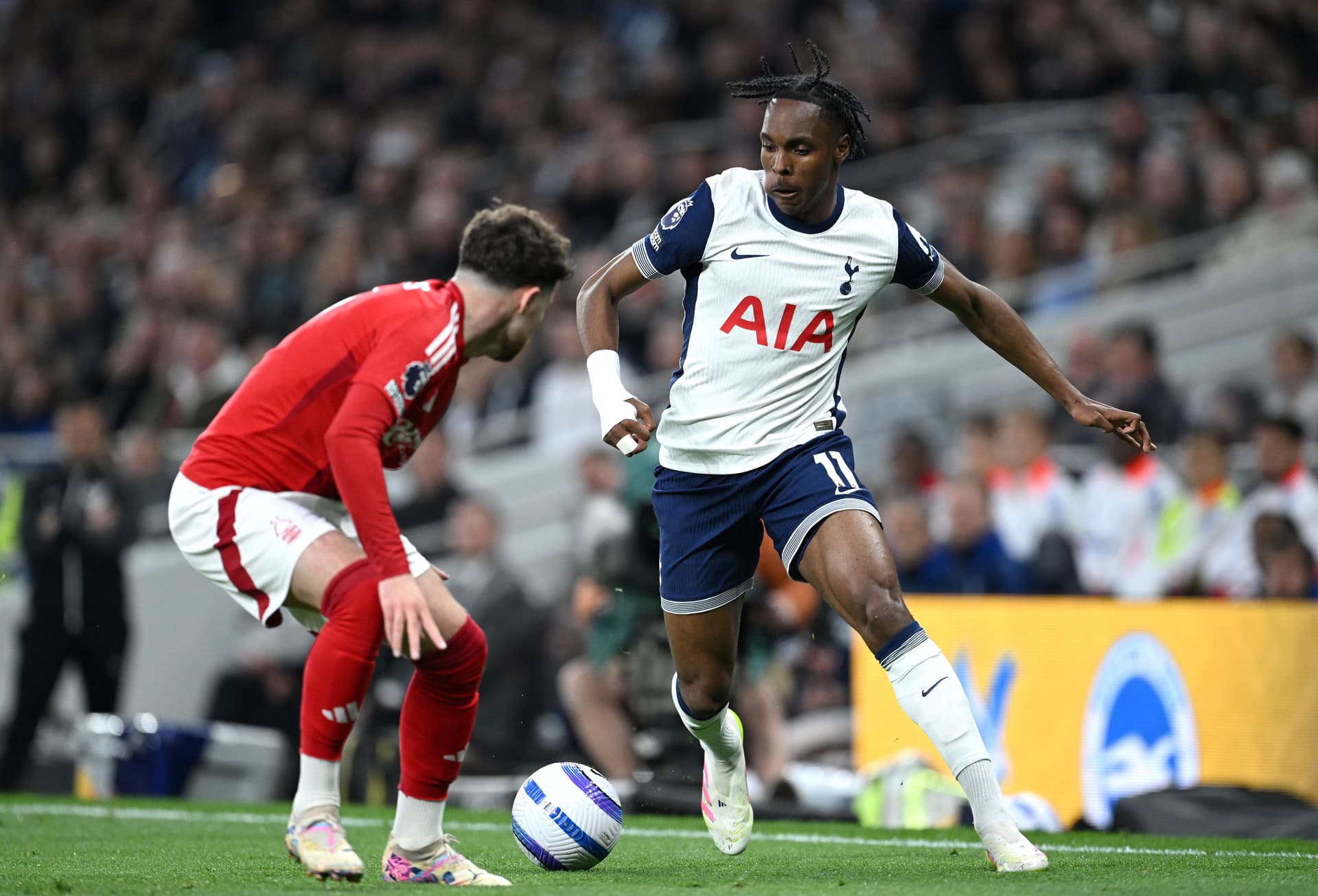 Mathys Tel of Tottenham Hotspur runs with the ball whilst under pressure