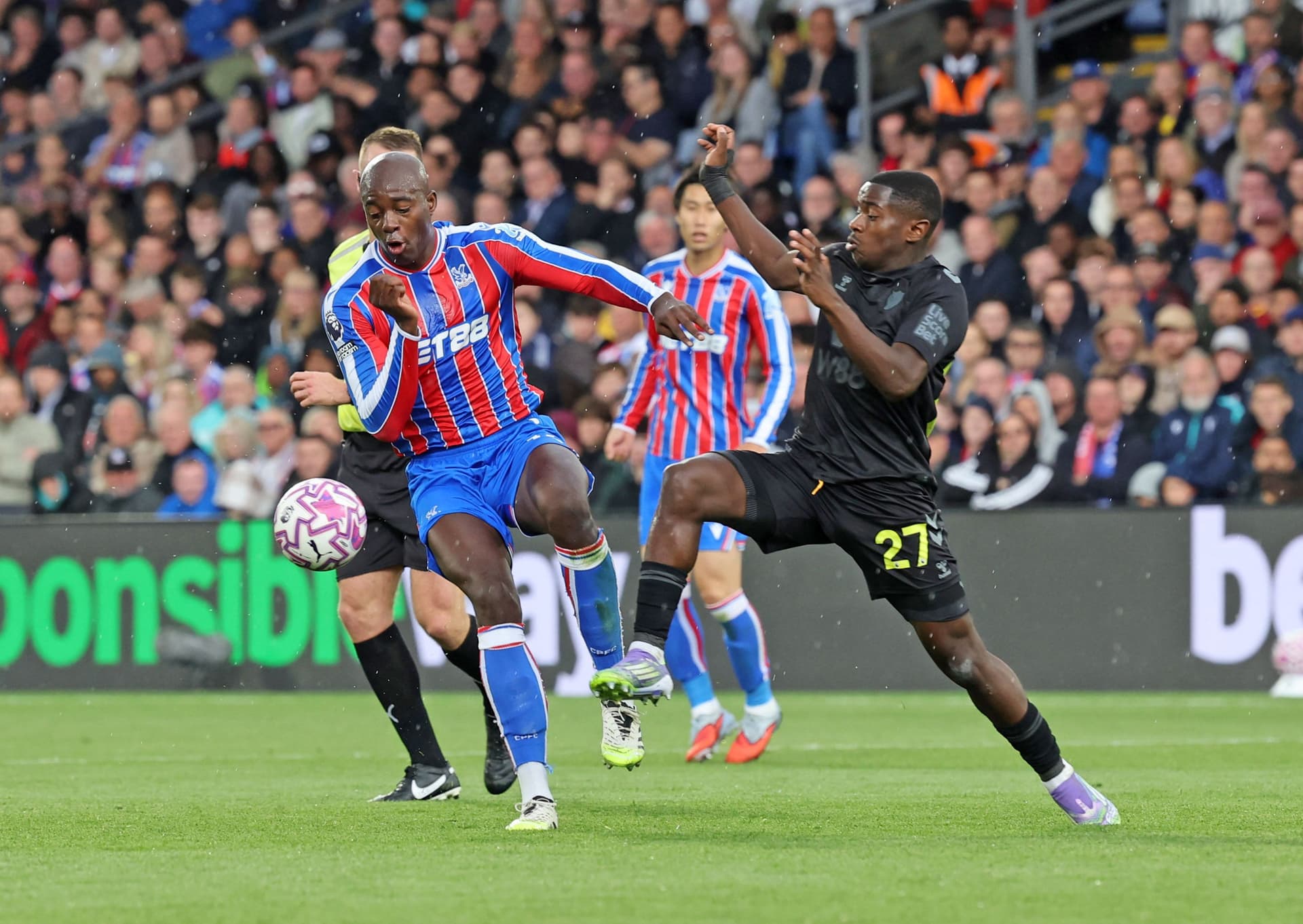 Noah Sadiki of Sunderland (R) tackles Jean-Philippe Mateta of Crystal Palace