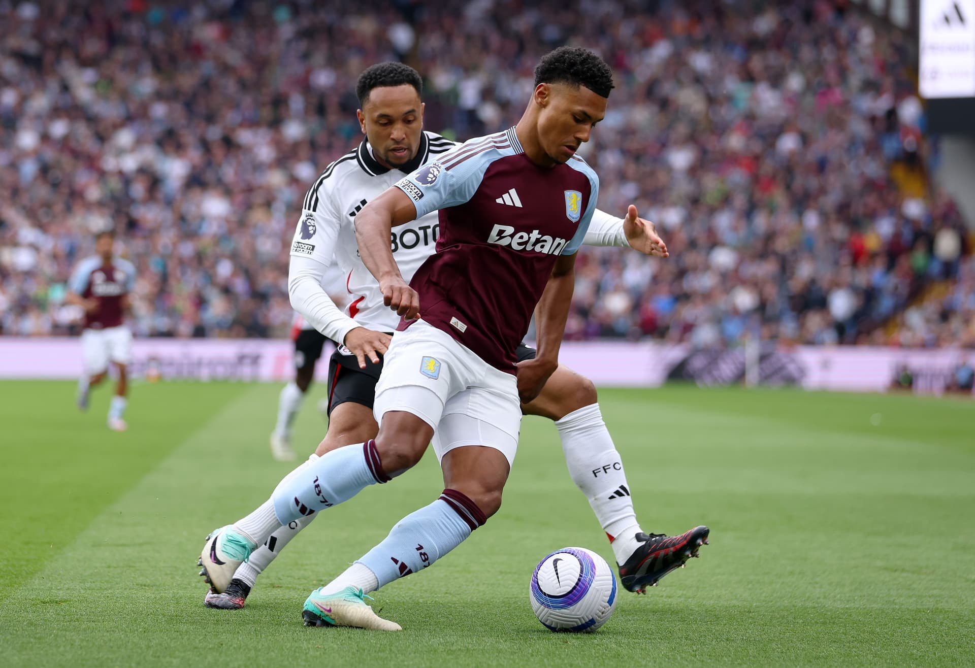 Ollie Watkins of Aston Villa is challenged by Kenny Tete of Fulham during the Premier League match
