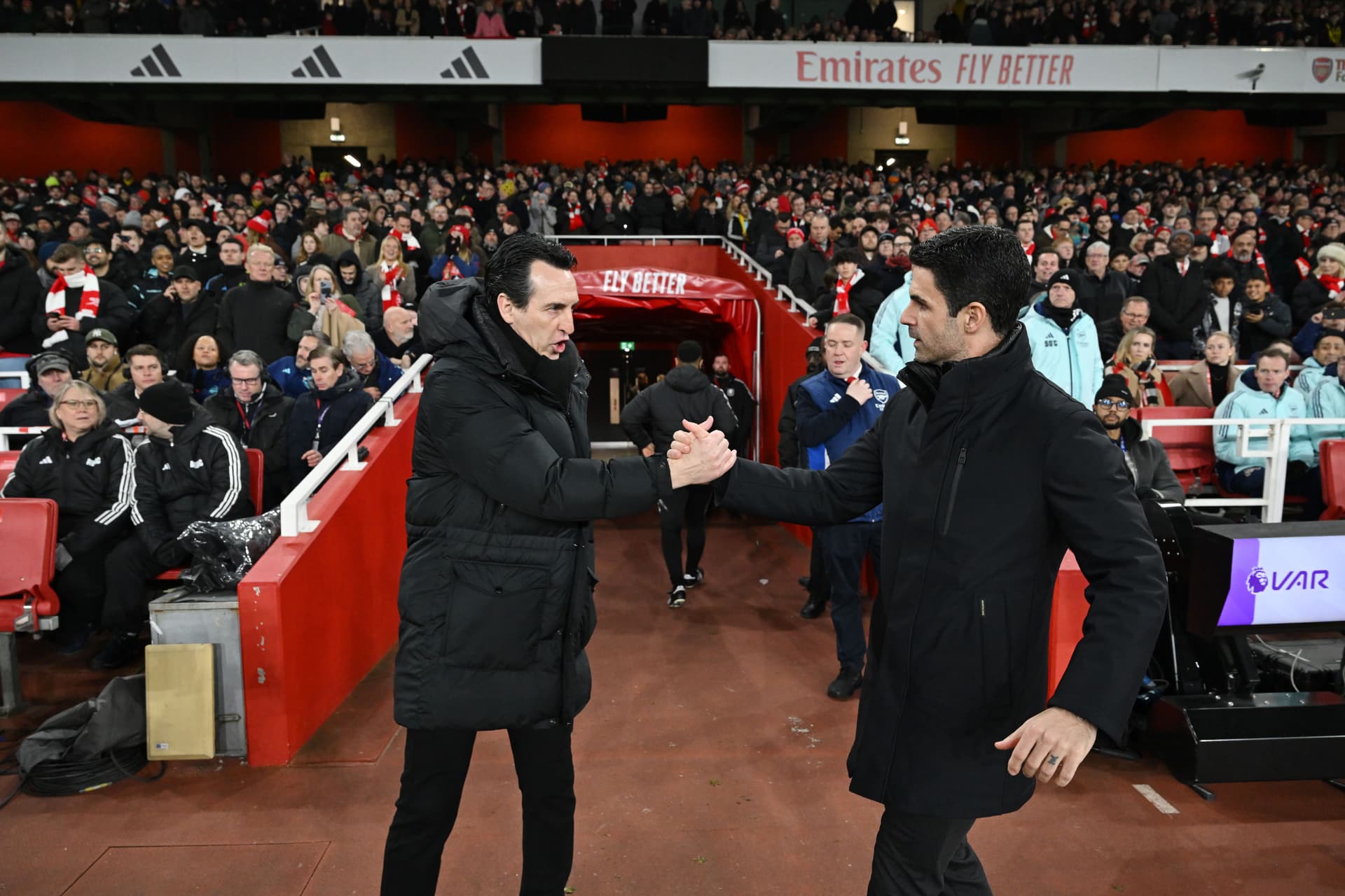 Unai Emery, Manager of Aston Villa, embraces Mikel Arteta, Manager of Arsenal,